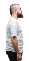 Young caucasian hipster man wearing casual t-shirt over isolated background looking to side, relax profile pose with natural face with confident smile.