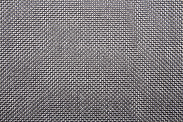 The texture of a dense gray carpet.The texture of gray woolen fabric.Grey braided background.