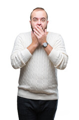Young caucasian hipster man wearing winter sweater over isolated background shocked covering mouth...
