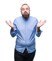 Young caucasian hipster man over isolated background clueless and confused expression with arms and...