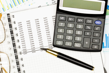 Top view office table desk. Financial report. Flat lay. Workspace with Business office supplies, Accounts number on the data paper, pen, glasses, calculator on the table. Top view. Close-up