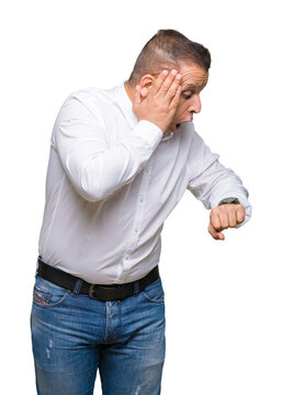 Middle age arab elegant man over isolated background Looking at the watch time worried, afraid of getting late