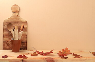 Empty wooden table with kitchen utensils and maple leaves,eco concept,kitchen mockup for design and...