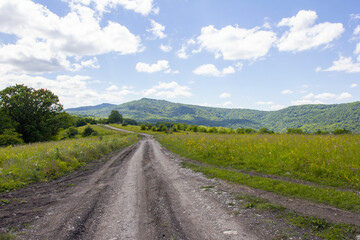 dirt roads on subalpine meadows in a mountainous area on a summer day .*