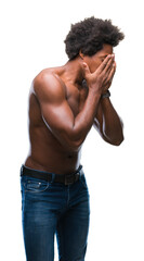 Fototapeta premium Afro american shirtless man showing nude body over isolated background with sad expression covering face with hands while crying. Depression concept.