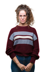 Beautiful brunette curly hair young girl wearing glasses over isolated background with serious expression on face. Simple and natural looking at the camera.