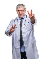 Handsome senior doctor man over isolated background smiling looking to the camera showing fingers doing victory sign. Number two.