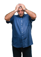 Handsome senior man over isolated background suffering from headache desperate and stressed because pain and migraine. Hands on head.