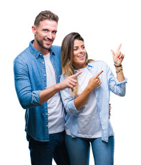 Young couple in love over isolated background smiling and looking at the camera pointing with two hands and fingers to the side.