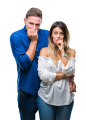 Young couple in love over isolated background looking stressed and nervous with hands on mouth biting nails. Anxiety problem.