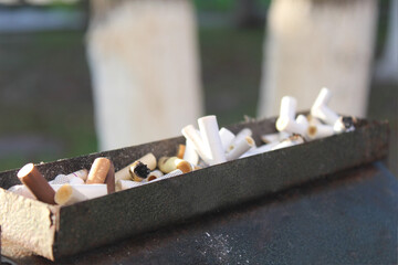 The concept of many broken cigarettes after smoking. Cigarette butts.