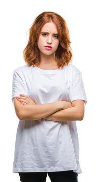 Young beautiful woman over isolated background skeptic and nervous, disapproving expression on face with crossed arms. Negative person.