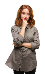 Young beautiful woman over isolated background looking confident at the camera with smile with crossed arms and hand raised on chin. Thinking positive.