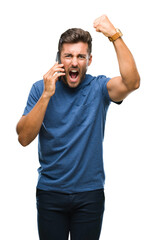 Young handsome man talking on smartphone over isolated background annoyed and frustrated shouting with anger, crazy and yelling with raised hand, anger concept