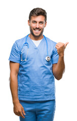 Young handsome doctor surgeon man over isolated background smiling with happy face looking and...