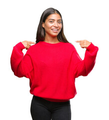 Young beautiful arab woman wearing winter sweater over isolated background looking confident with smile on face, pointing oneself with fingers proud and happy.
