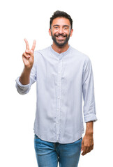 Adult hispanic man over isolated background smiling with happy face winking at the camera doing...