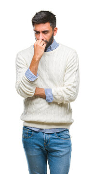 Adult hispanic man wearing winter sweater over isolated background looking stressed and nervous with hands on mouth biting nails. Anxiety problem.