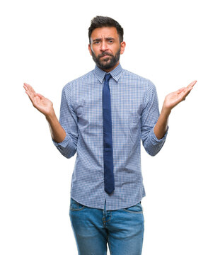 Adult hispanic business man over isolated background clueless and confused expression with arms and hands raised. Doubt concept.