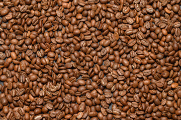 Texture of roasted aromatic brown coffee beans.