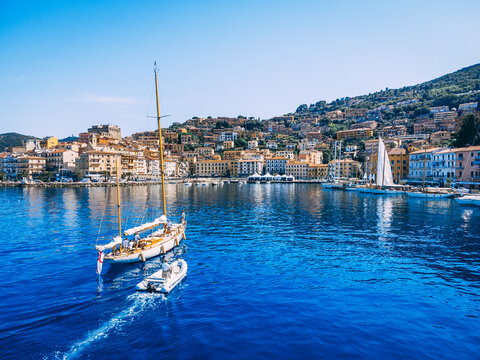Sailing yachts coming back to the beautiful marina in Argentario, Italy