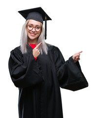 Young blonde woman wearing graduate uniform over isolated background smiling and looking at the...