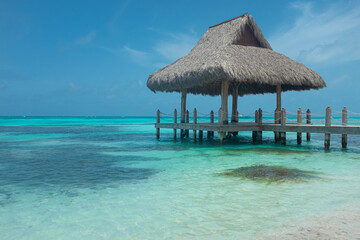 Caribbean beach cabin with clear sea water and blue sky
