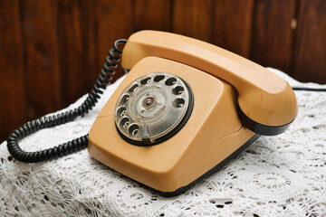 Old-fashioned retro style plastic telephone with rotary dial. Vintage plastic phone.