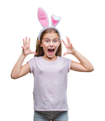 Young beautiful girl wearing easter bunny ears over isolated background celebrating crazy and...