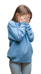 Young beautiful girl wearing winter sweater over isolated background with sad expression covering...