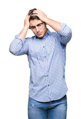 Young handsome man wearing glasses over isolated background suffering from headache desperate and stressed because pain and migraine. Hands on head.