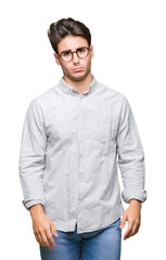 Fototapeta premium Young handsome man wearing glasses over isolated background depressed and worry for distress, crying angry and afraid. Sad expression.
