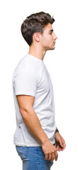 Young handsome man wearing white t-shirt over isolated background looking to side, relax profile...