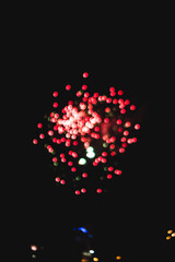 Coloured bokeh of firework in darkness