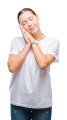 Young beautiful caucasian woman over isolated background sleeping tired dreaming and posing with hands together while smiling with closed eyes.