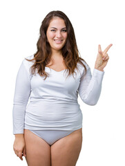 Beautiful plus size young overwight woman wearing white underwear over isolated background smiling with happy face winking at the camera doing victory sign. Number two.