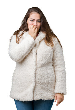 Beautiful plus size young woman wearing winter sheep coat over isolated background looking stressed and nervous with hands on mouth biting nails. Anxiety problem.
