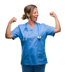 Middle age senior nurse doctor woman over isolated background showing arms muscles smiling proud....