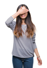 Fototapeta premium Young asian woman wearing glasses over isolated background smiling and laughing with hand on face covering eyes for surprise. Blind concept.
