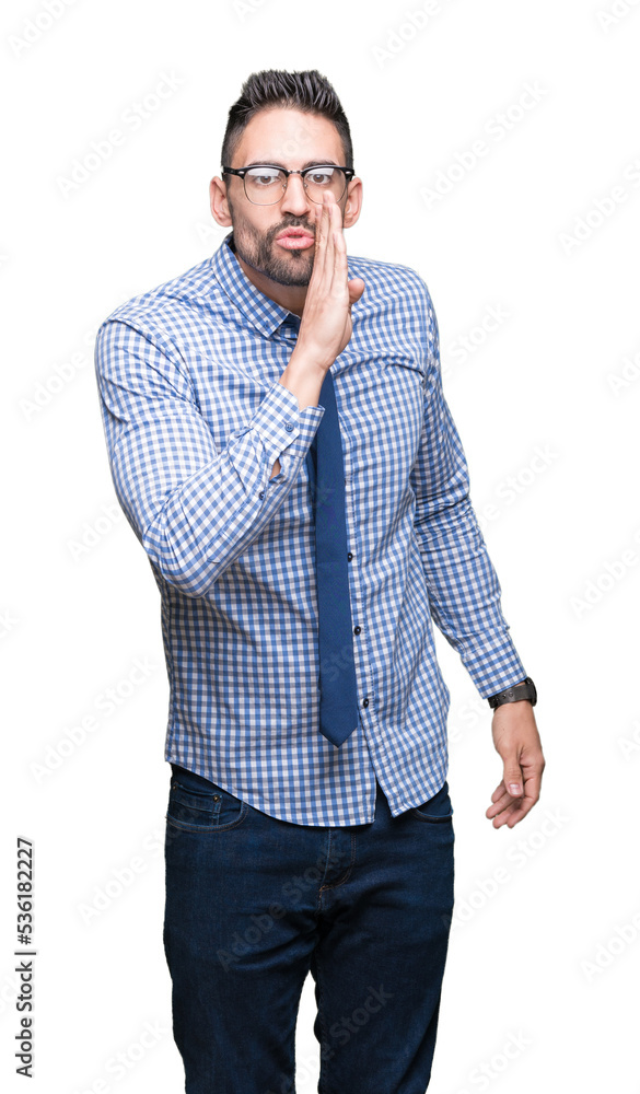 Canvas Prints young business man wearing glasses over isolated background hand on mouth telling secret rumor, whis