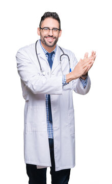 Handsome young doctor man over isolated background Clapping and applauding happy and joyful, smiling proud hands together