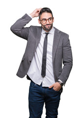 Young handsome business man over isolated background confuse and wonder about question. Uncertain with doubt, thinking with hand on head. Pensive concept.