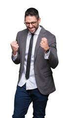 Young handsome business man over isolated background very happy and excited doing winner gesture with arms raised, smiling and screaming for success. Celebration concept.