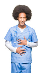 Young african american doctor man with afro hair with hand on stomach because nausea, painful disease feeling unwell. Ache concept.
