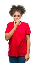 Fototapeta na wymiar Young afro american woman over isolated background touching mouth with hand with painful expression because of toothache or dental illness on teeth. Dentist concept.