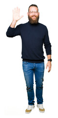 Young blond man wearing glasses and turtleneck sweater Waiving saying hello happy and smiling, friendly welcome gesture