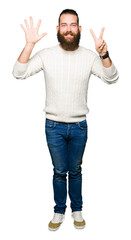 Young hipster man wearing winter sweater showing and pointing up with fingers number seven while smiling confident and happy.