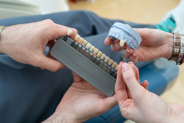 selection of the color of the denture on the template in dentistry