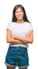 Obraz premium Young asian woman over isolated background happy face smiling with crossed arms looking at the camera. Positive person.