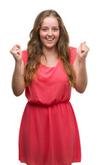 Young blonde woman wearing pink dress screaming proud and celebrating victory and success very excited, cheering emotion